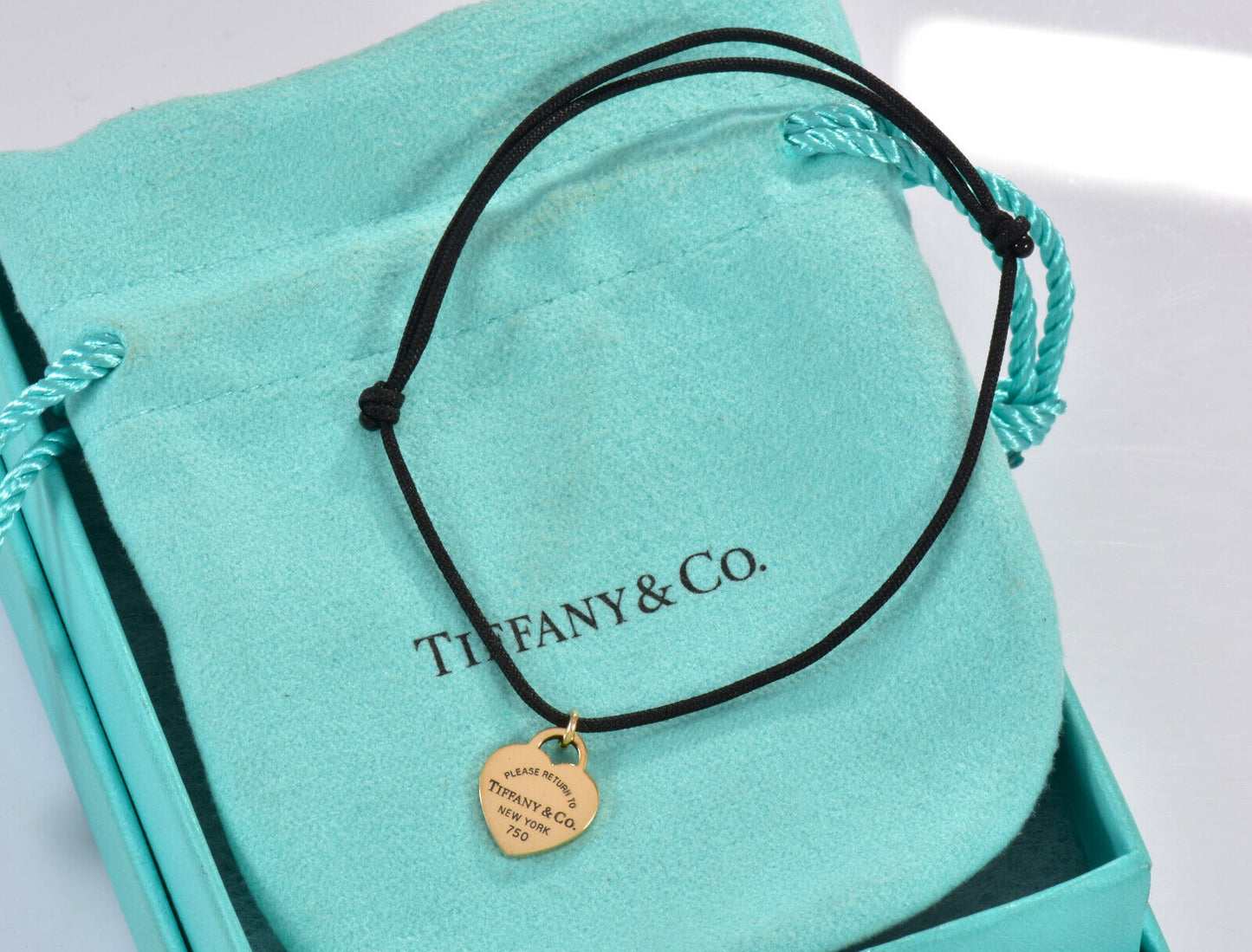 Please Return To Tiffany & Co 18K Yellow Gold Heart Black Cord Bracelet in Box